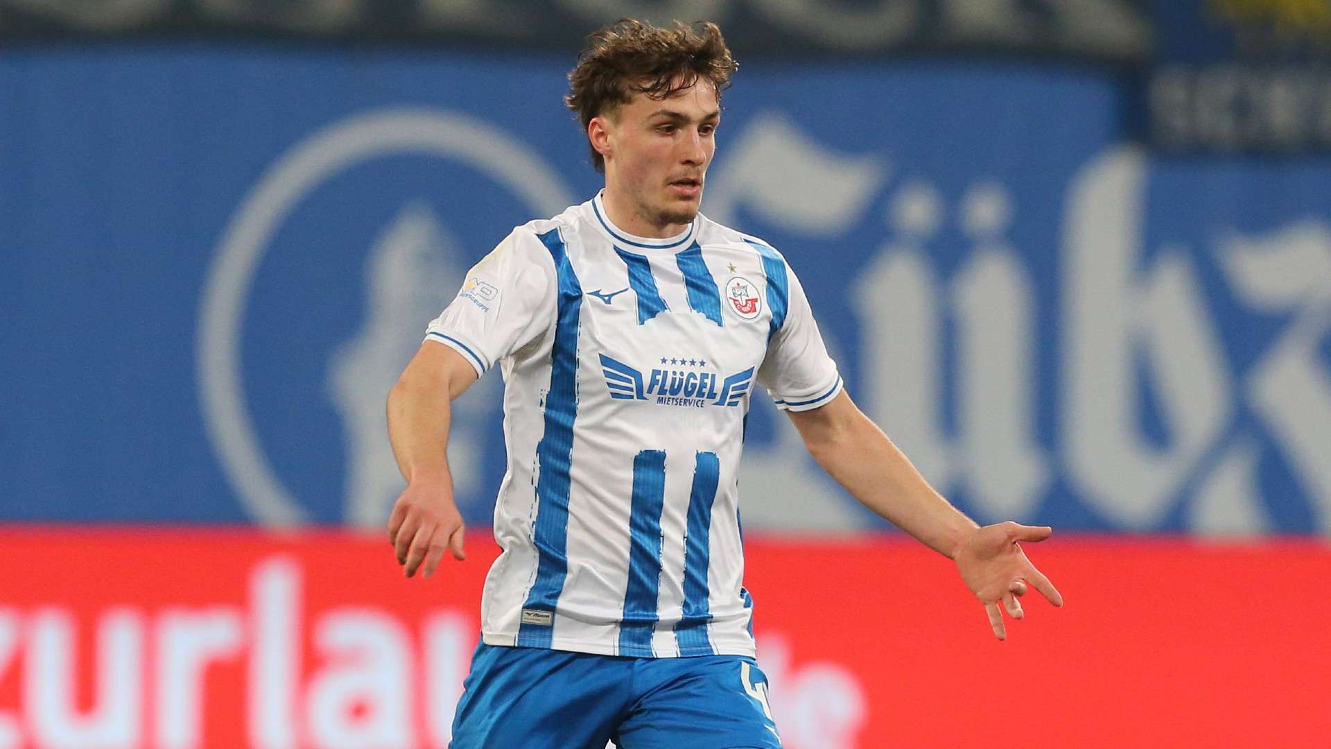 Benno Johannes Dietze of Rostock runs with the ball
